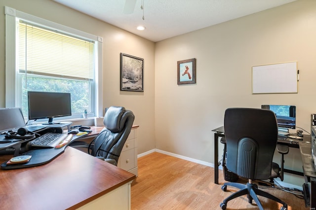 office featuring baseboards, recessed lighting, light wood-style flooring, a textured ceiling, and a ceiling fan