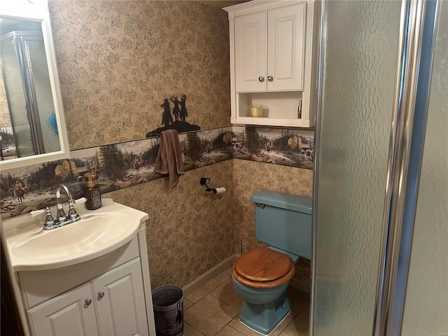 bathroom with wallpapered walls, toilet, a shower with shower door, tile patterned floors, and vanity