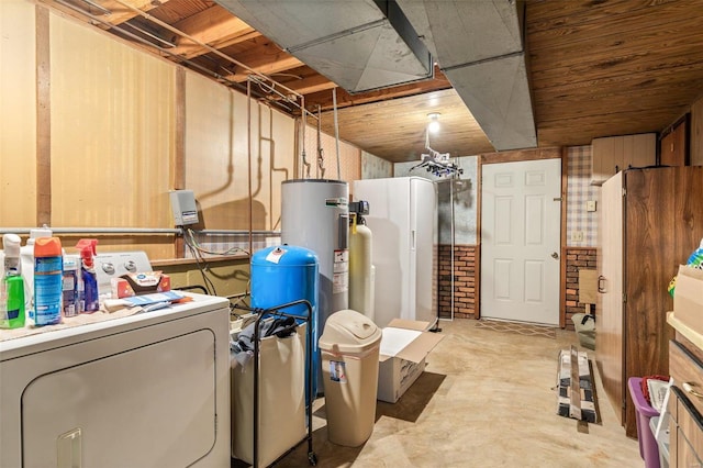 unfinished below grade area with washer / dryer, freestanding refrigerator, and electric water heater