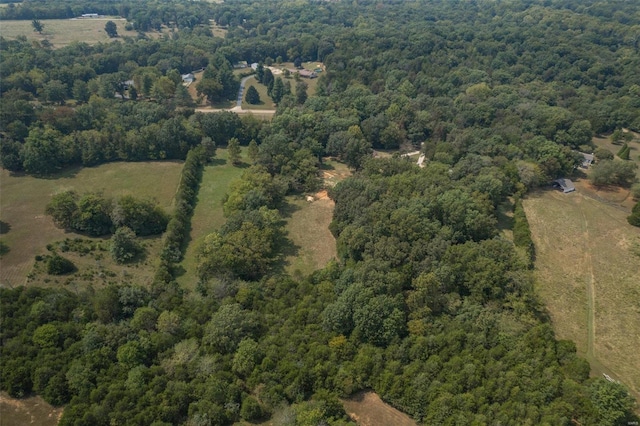 birds eye view of property featuring a view of trees