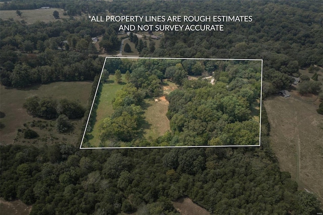 birds eye view of property with a forest view