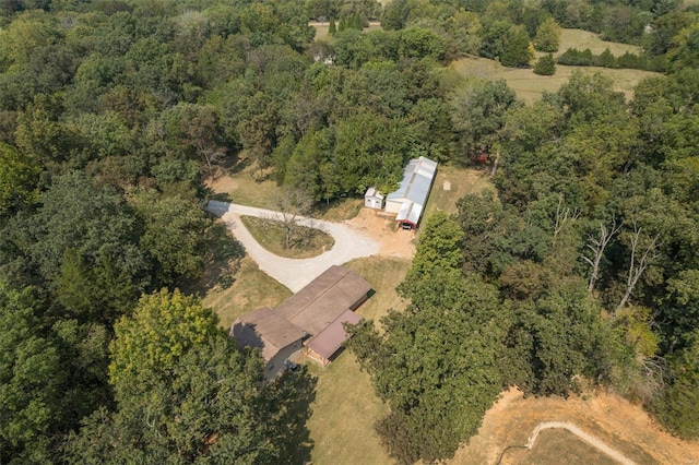 birds eye view of property with a forest view