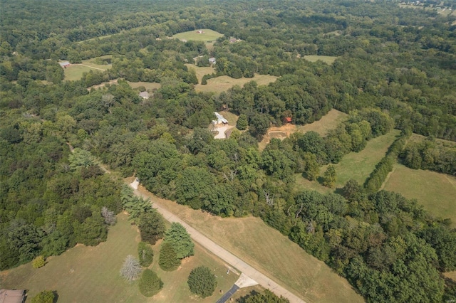 drone / aerial view featuring a view of trees