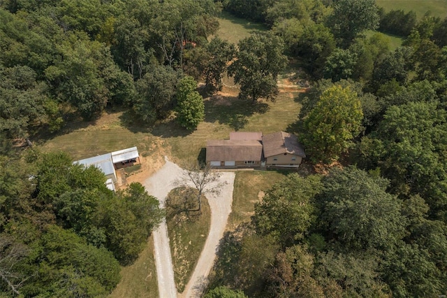 drone / aerial view with a wooded view