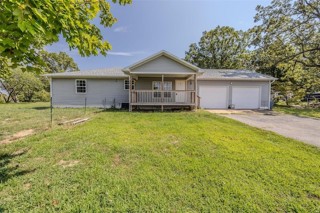 ranch-style home with a garage and a front lawn