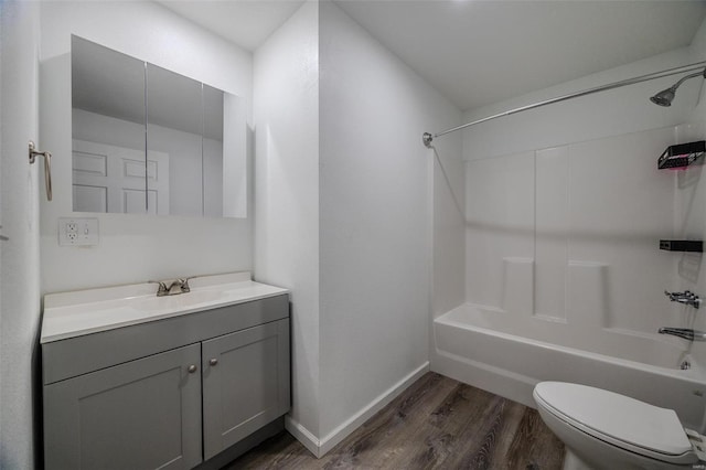 full bathroom with vanity, toilet, shower / washtub combination, and hardwood / wood-style flooring