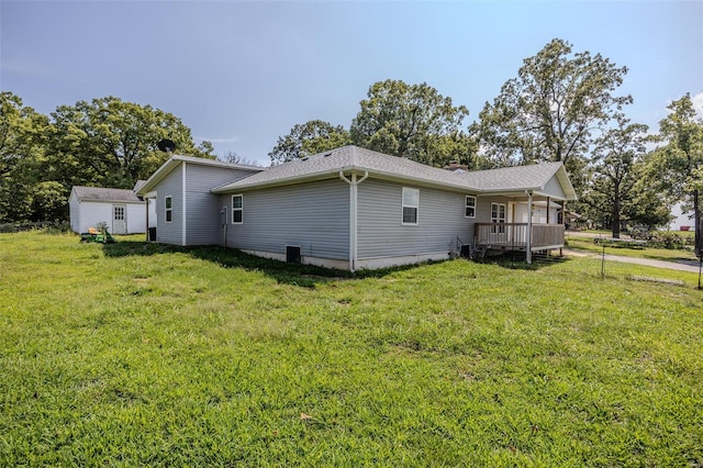 view of side of home with a lawn and an outdoor structure