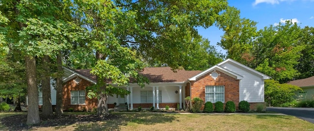 ranch-style home featuring a front yard and a porch