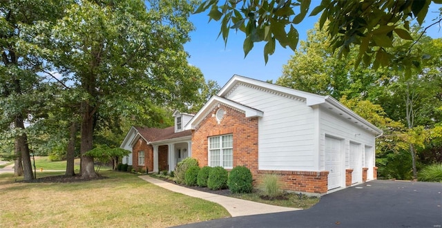 view of side of property featuring a lawn and a garage