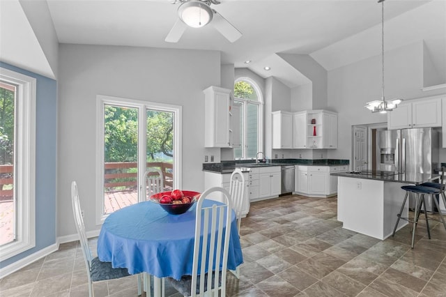 kitchen with white cabinets, pendant lighting, a wealth of natural light, and appliances with stainless steel finishes