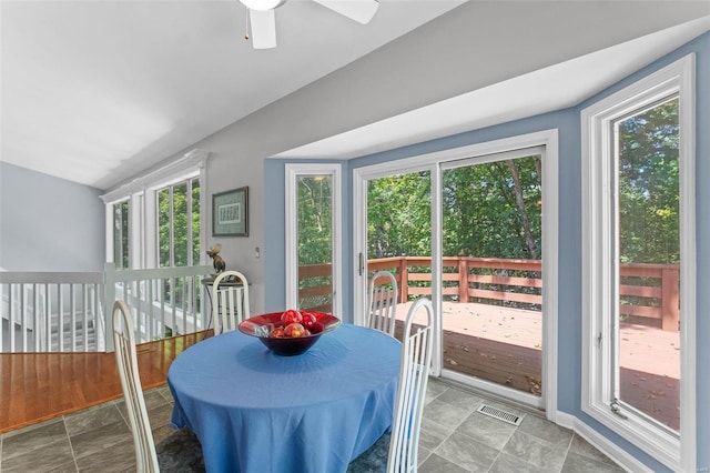 dining area with vaulted ceiling, ceiling fan, and a healthy amount of sunlight