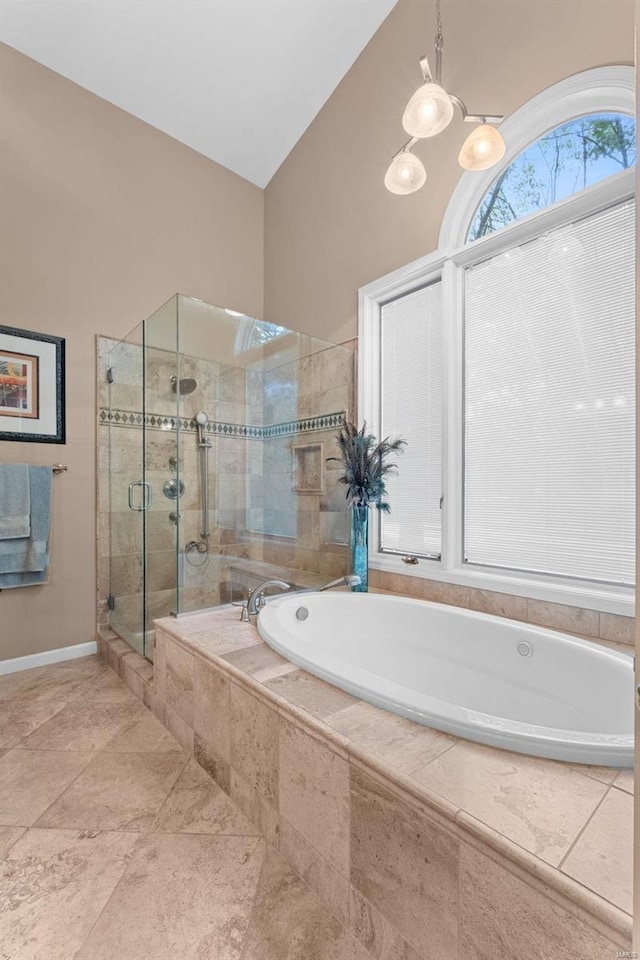 bathroom featuring separate shower and tub and lofted ceiling