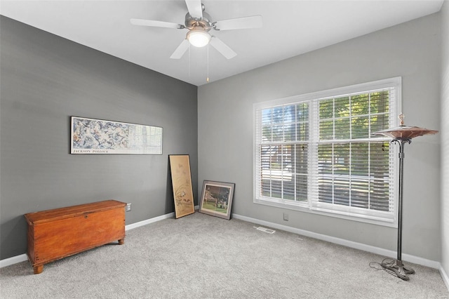 empty room with light colored carpet and ceiling fan