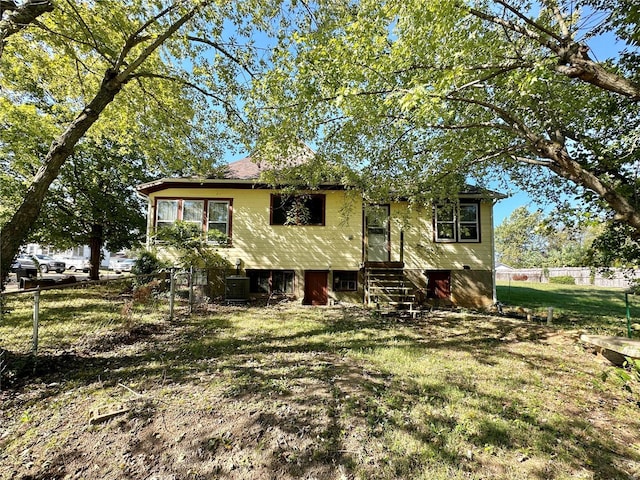 exterior space featuring central AC unit and a lawn