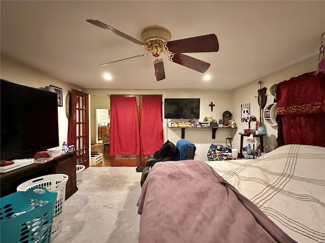 bedroom with ceiling fan and light colored carpet