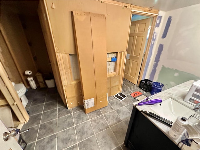 bathroom featuring vanity, tile patterned flooring, and toilet