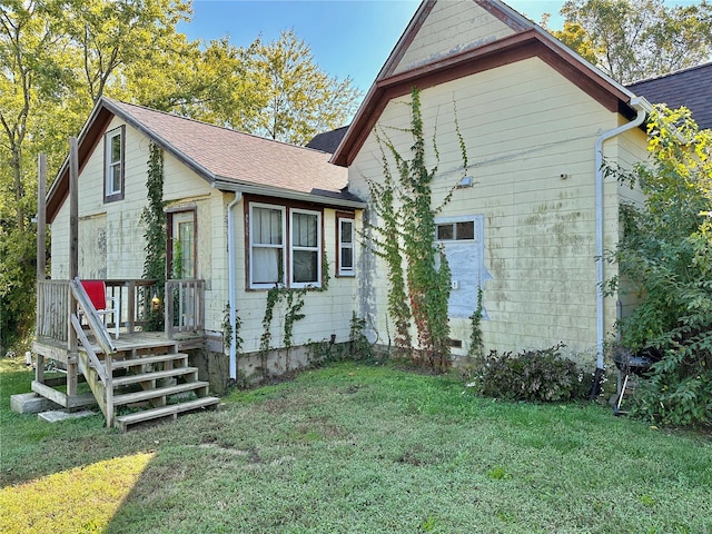 back of house with a lawn