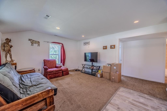 living room with vaulted ceiling and light hardwood / wood-style floors