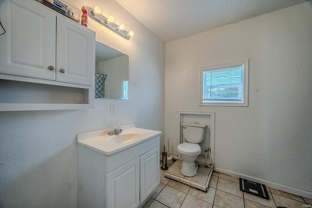 bathroom featuring vanity, toilet, and tile patterned floors