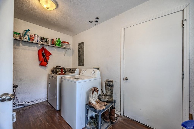 laundry area with dark hardwood / wood-style floors, independent washer and dryer, and a textured ceiling