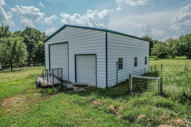 view of outdoor structure featuring a yard and a garage