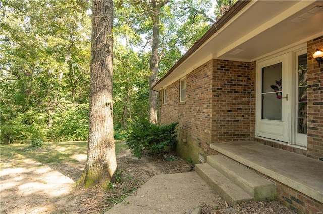 view of side of property featuring brick siding