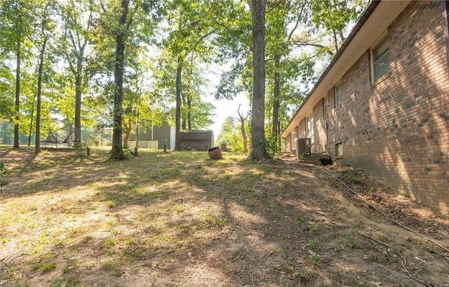 view of yard featuring central air condition unit