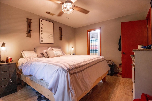 bedroom with wood-type flooring and ceiling fan