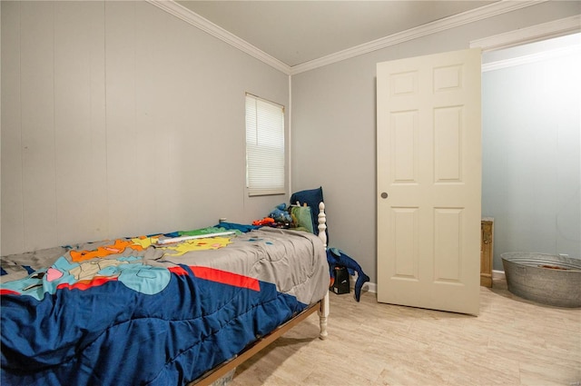 bedroom featuring light wood-style flooring and crown molding