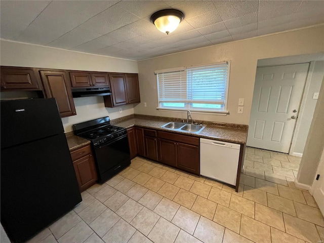 kitchen with exhaust hood, black appliances, light tile patterned floors, sink, and dark brown cabinetry