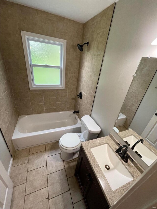 full bathroom featuring tiled shower / bath combo, vanity, toilet, and tile patterned flooring