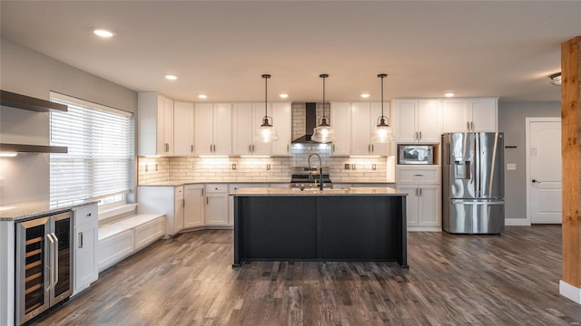 kitchen with stainless steel appliances, white cabinets, wine cooler, and decorative light fixtures