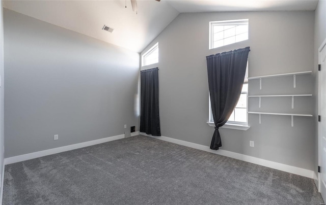 carpeted spare room with high vaulted ceiling and ceiling fan