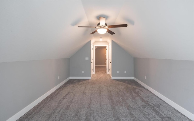 additional living space with vaulted ceiling, carpet floors, and ceiling fan