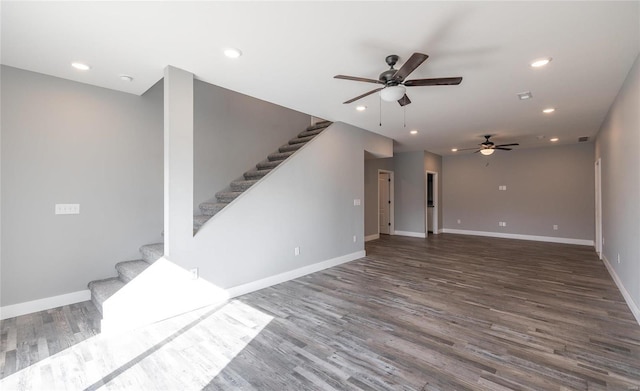 unfurnished living room with ceiling fan and dark hardwood / wood-style flooring