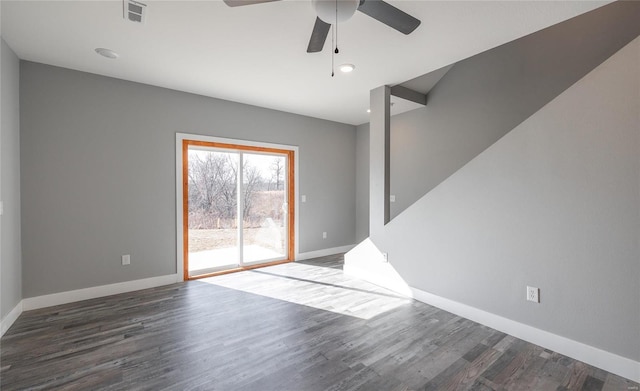 spare room featuring dark wood-type flooring and ceiling fan