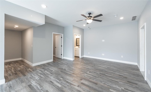 spare room featuring dark hardwood / wood-style flooring and ceiling fan