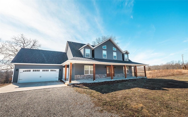 farmhouse inspired home featuring a garage, a front yard, and a porch