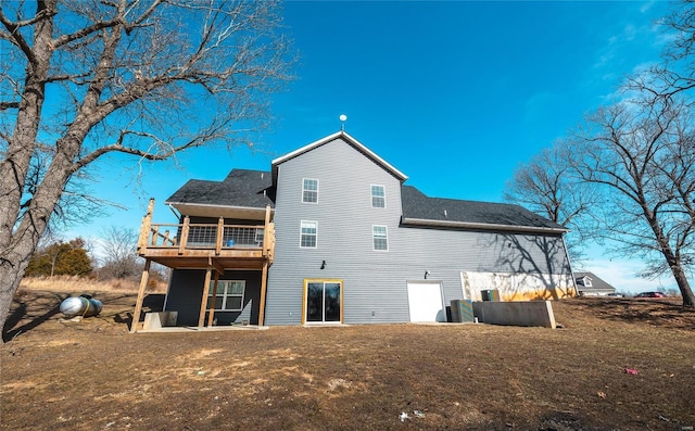 rear view of property featuring a lawn