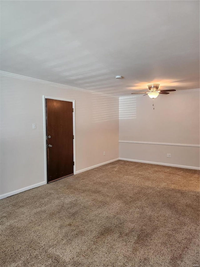 carpeted empty room with ceiling fan and ornamental molding