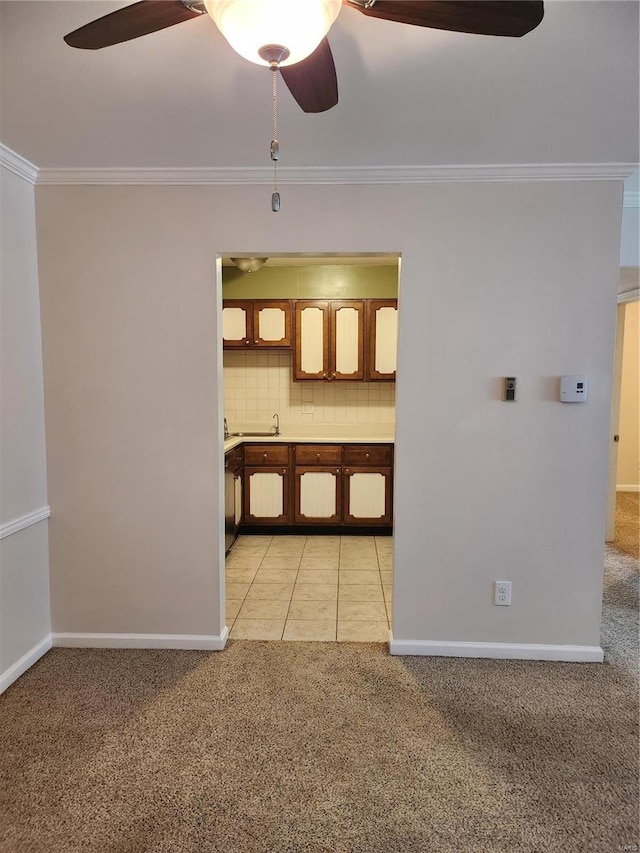 kitchen with light carpet, crown molding, tasteful backsplash, and ceiling fan