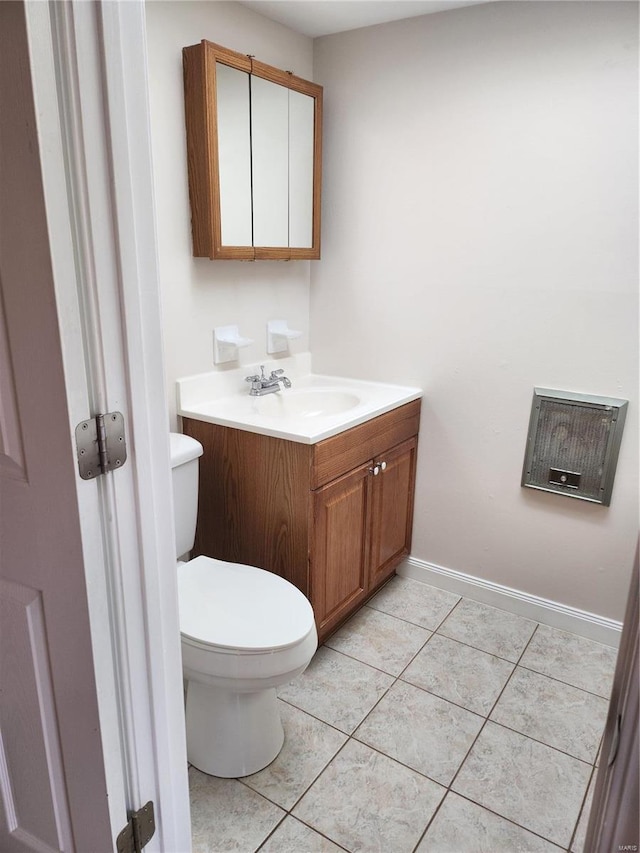 bathroom featuring tile patterned flooring, toilet, and vanity