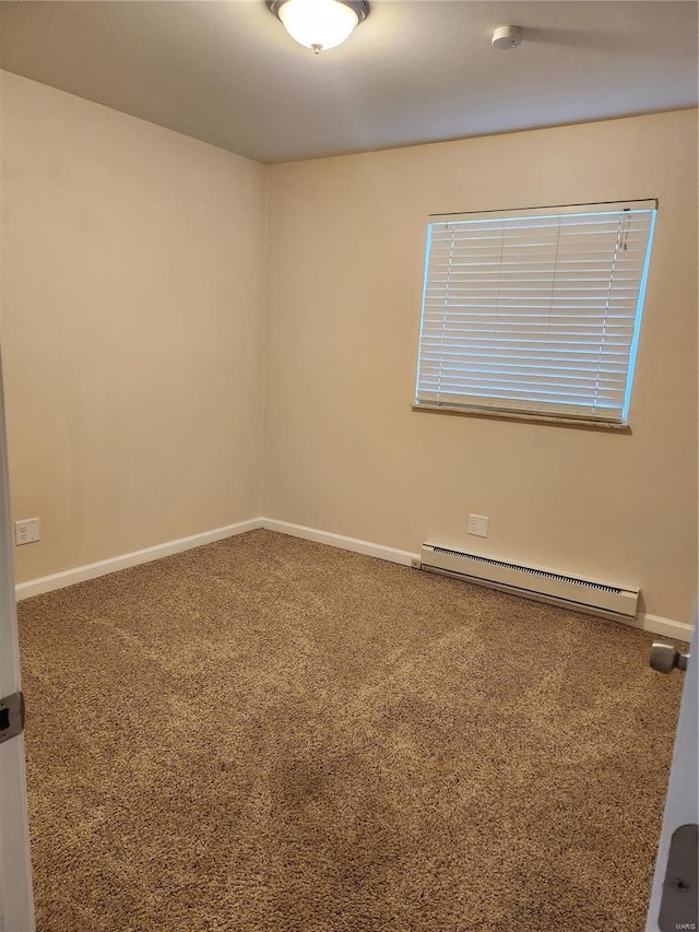 unfurnished room with a baseboard heating unit and carpet