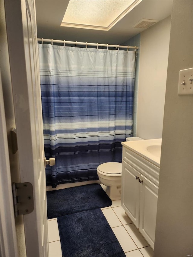 bathroom featuring tile patterned floors, a shower with curtain, toilet, and vanity