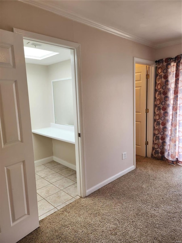 carpeted spare room featuring crown molding