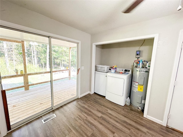 laundry room featuring washing machine and dryer, electric water heater, and hardwood / wood-style flooring