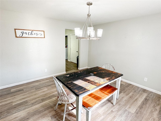 dining room featuring a chandelier and light hardwood / wood-style floors