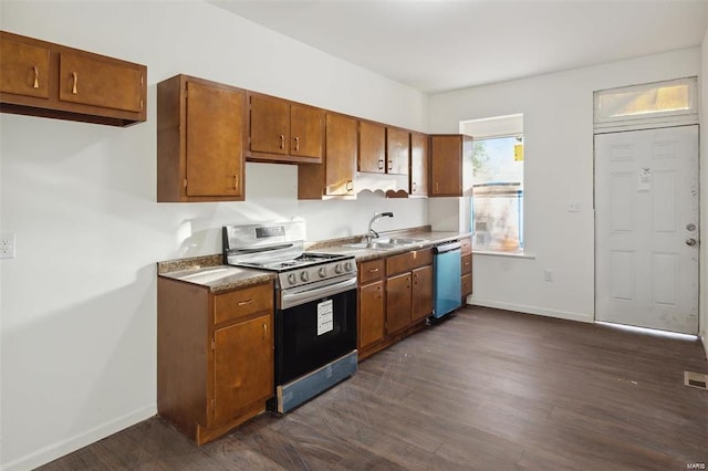 kitchen featuring stainless steel appliances, sink, and dark hardwood / wood-style floors