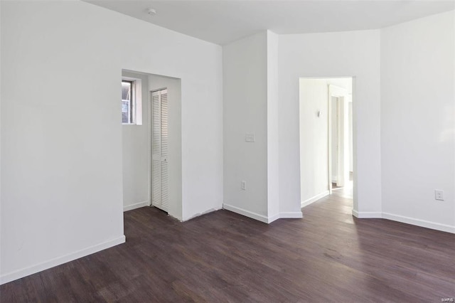 spare room featuring dark wood-type flooring