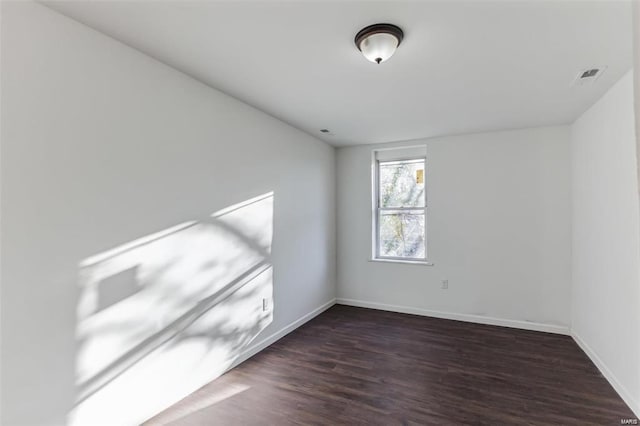 unfurnished room featuring dark hardwood / wood-style flooring